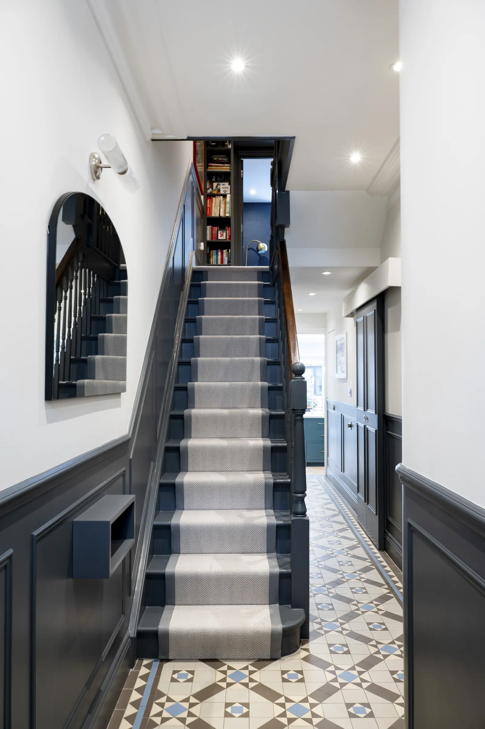 The hallway keeps a dark grey below the dado rail, over the original tiled floor.