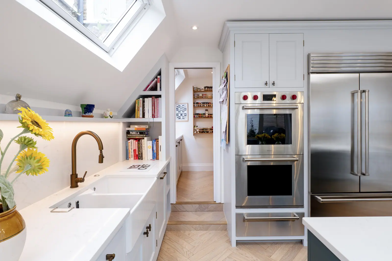 The kitchen run leads through to a walk-in pantry, with double ovens alongside.