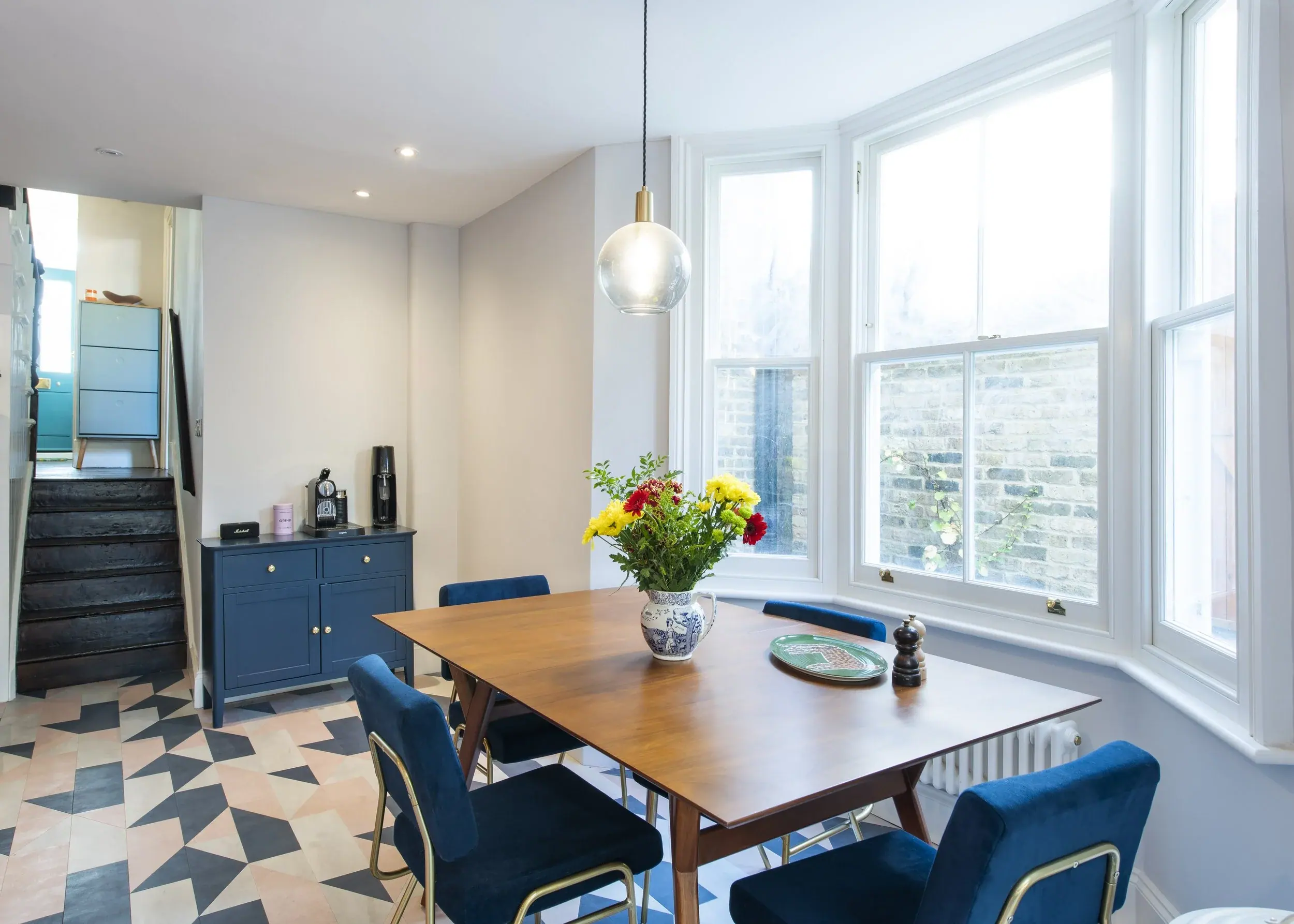 Dining room with bespoke blue joinery in an east London home by Studio Schubert